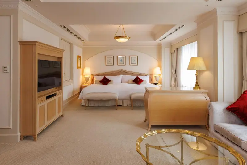 Une chambre lumineuse avec un grand lit et un coin salon.