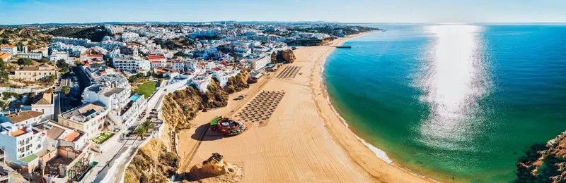 Vue aérienne d'une ville côtière avec une longue plage de sable.