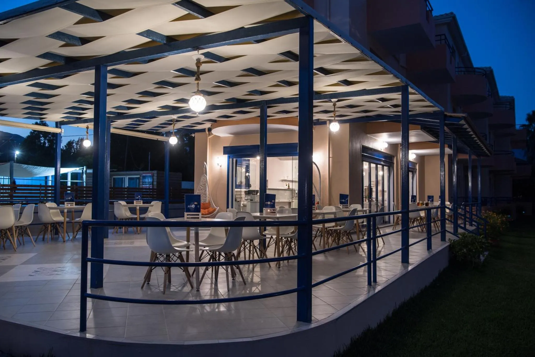 Terrasse ombragée avec tables et chaises pour les repas en extérieur.