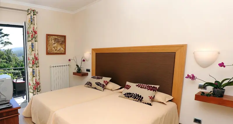 Une chambre lumineuse avec un grand lit et une décoration florale.