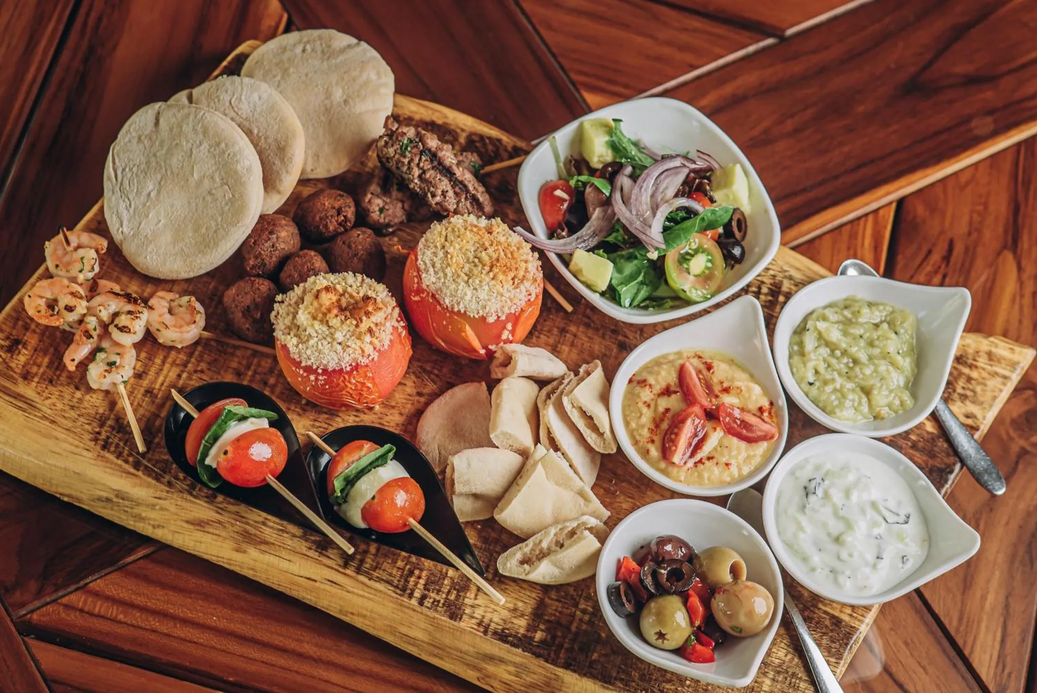 Assortiment de mets variés présentés sur une planche en bois.