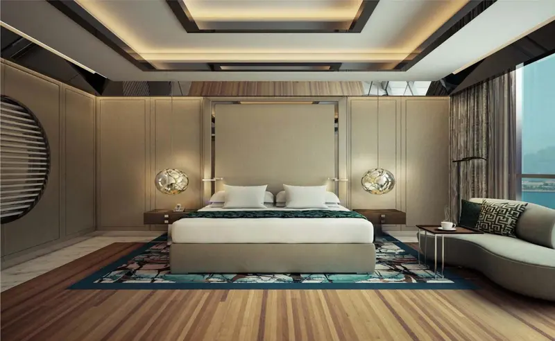Une chambre spacieuse avec un grand lit et un coin salon.
