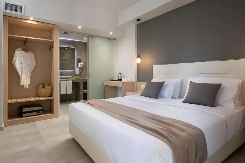 Une chambre moderne avec un grand lit et un espace ouvert sur la salle de bain.