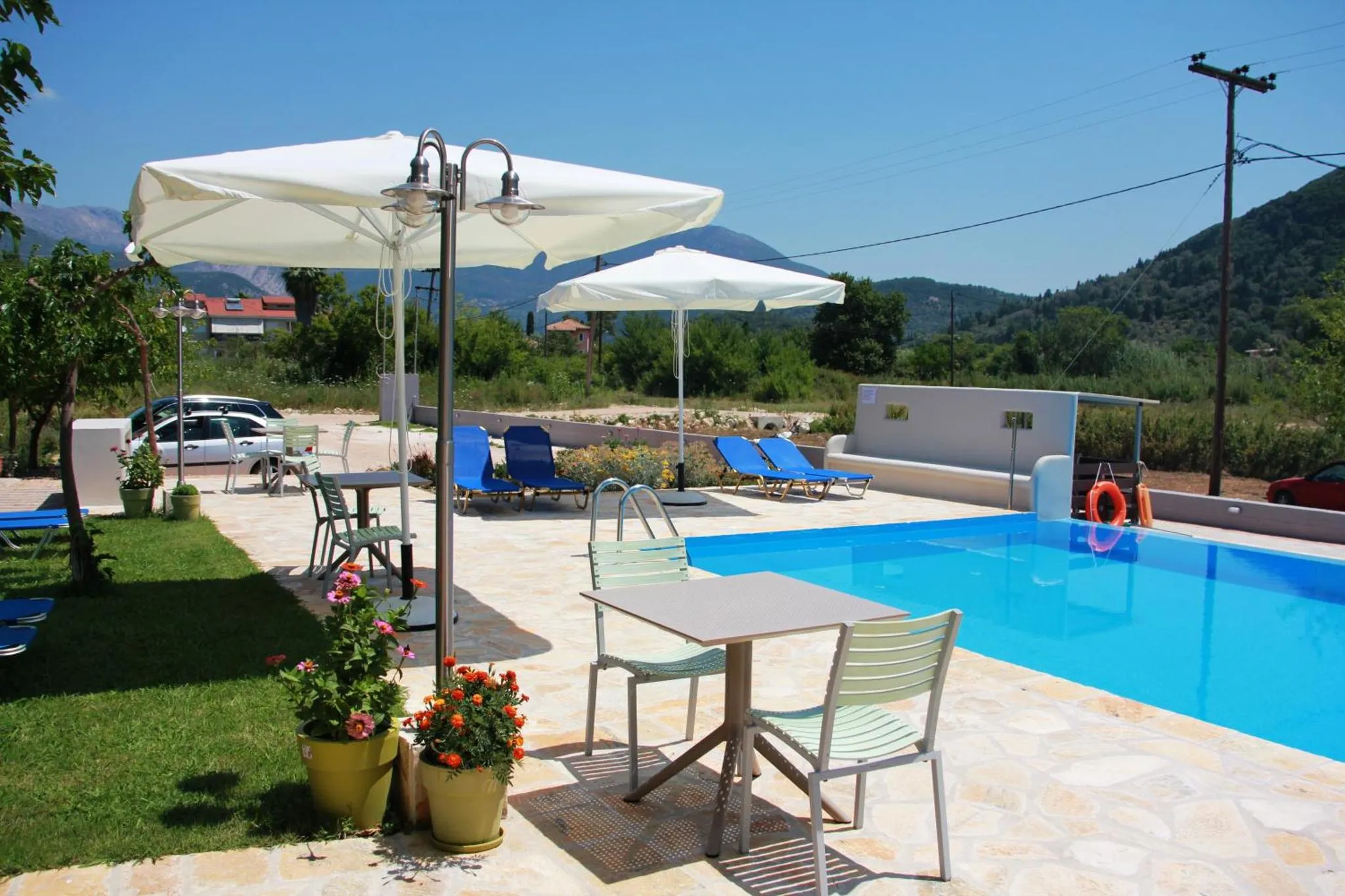 Terrasse avec transats et piscine ensoleillée.