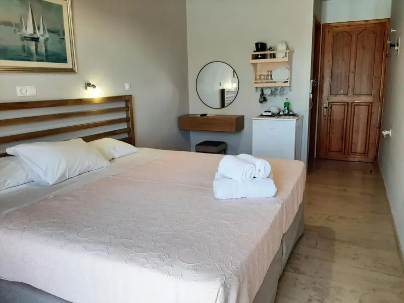 Une chambre lumineuse avec un grand lit et un décor mural.