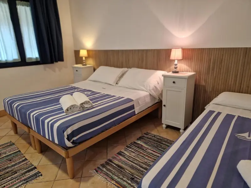 Une chambre avec deux lits et des tables de chevet.