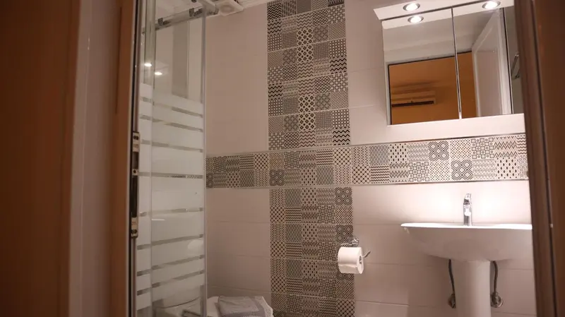 Une salle de bain moderne avec douche à l'italienne et carrelage décoratif.