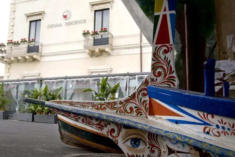 Façade d'un bâtiment avec un bateau décoré au premier plan.