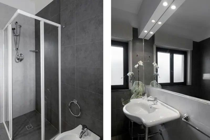 Douche à l'italienne et lavabo dans une salle de bain moderne.