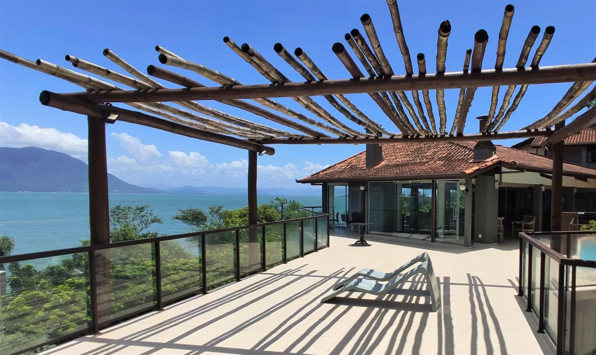 Terrasse aménagée avec mobilier de détente et vue sur la mer.