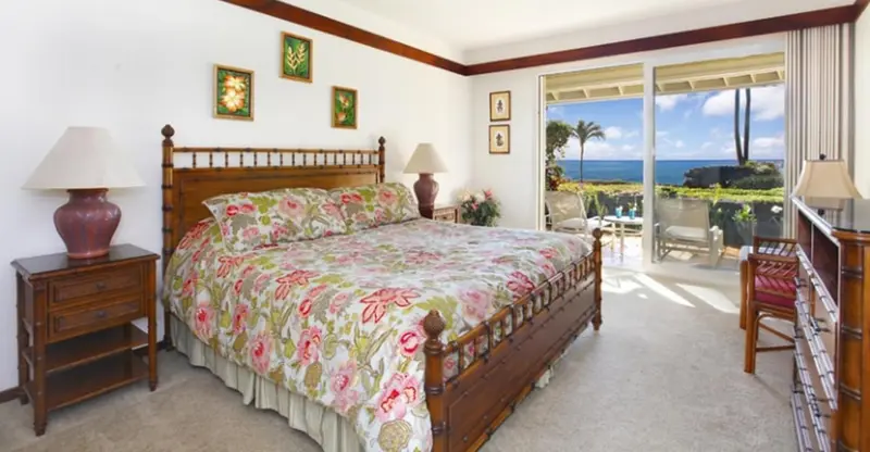 Une chambre lumineuse avec un grand lit et vue sur la mer.