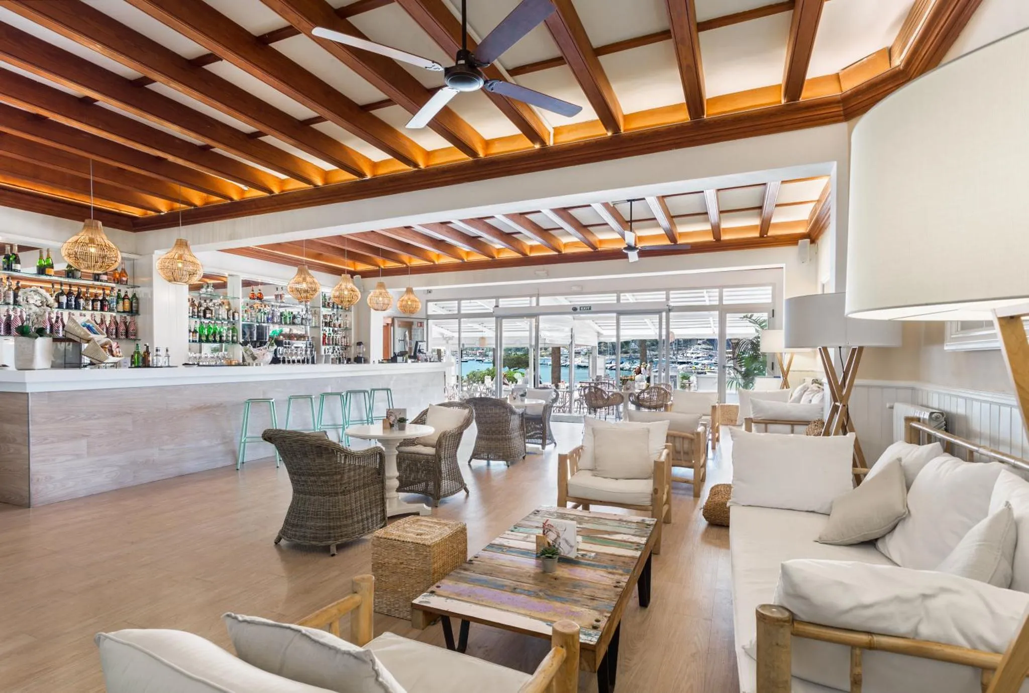 Un espace de détente avec un bar et des fauteuils confortables offre une vue sur la mer.