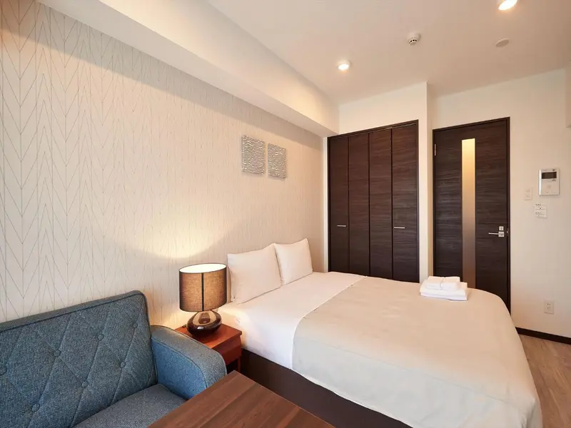 Une chambre lumineuse avec un lit et un canapé.