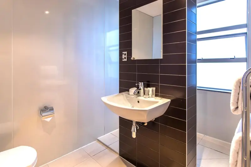 Une salle de bain moderne avec lavabo et douche à l'italienne.