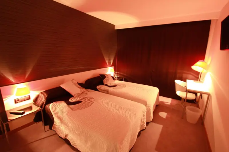 Une chambre à coucher avec un lit double et des lampes de chevet.