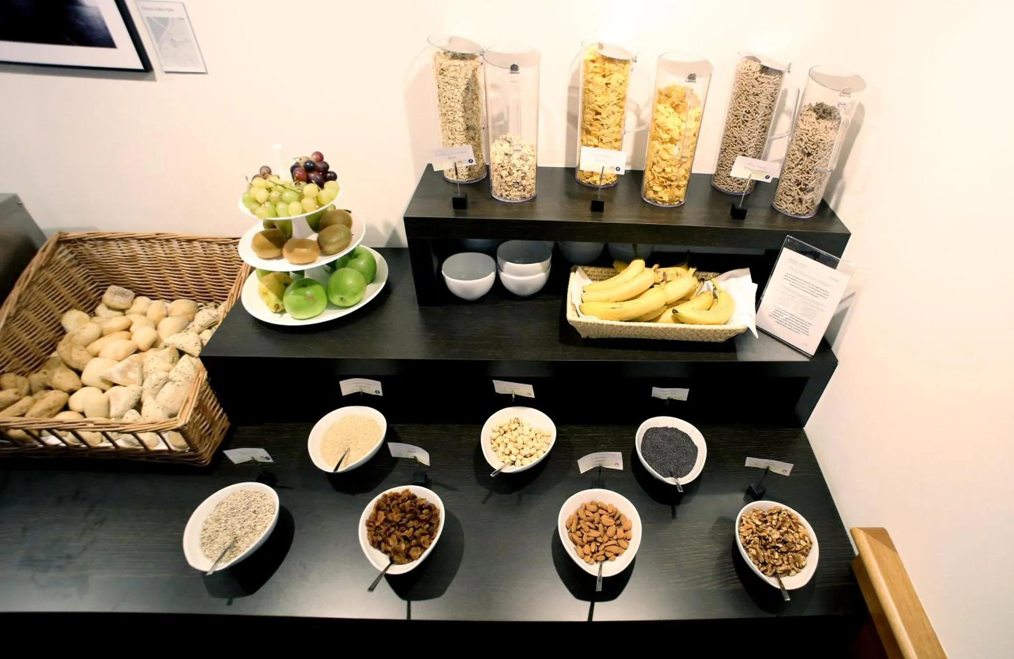 Un buffet propose des céréales, des fruits frais et des graines.