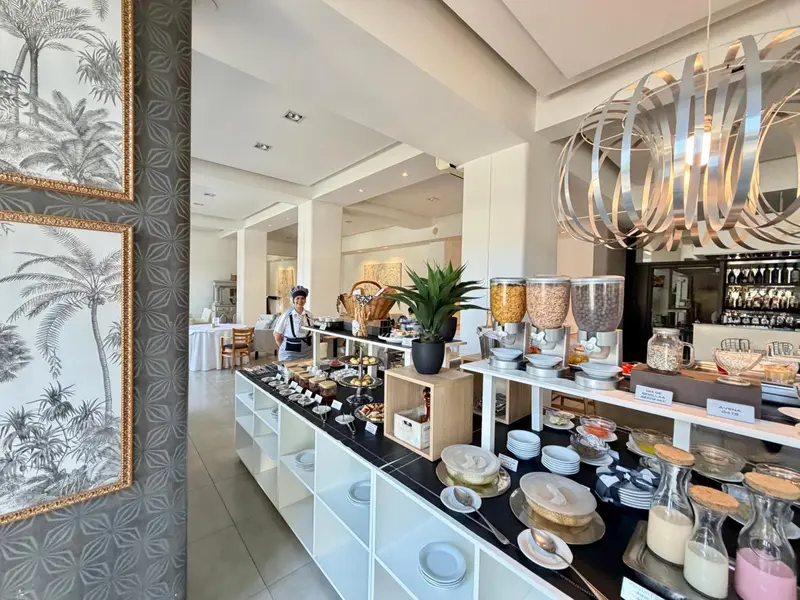 Un buffet propose une variété de plats et de boissons dans une salle lumineuse.