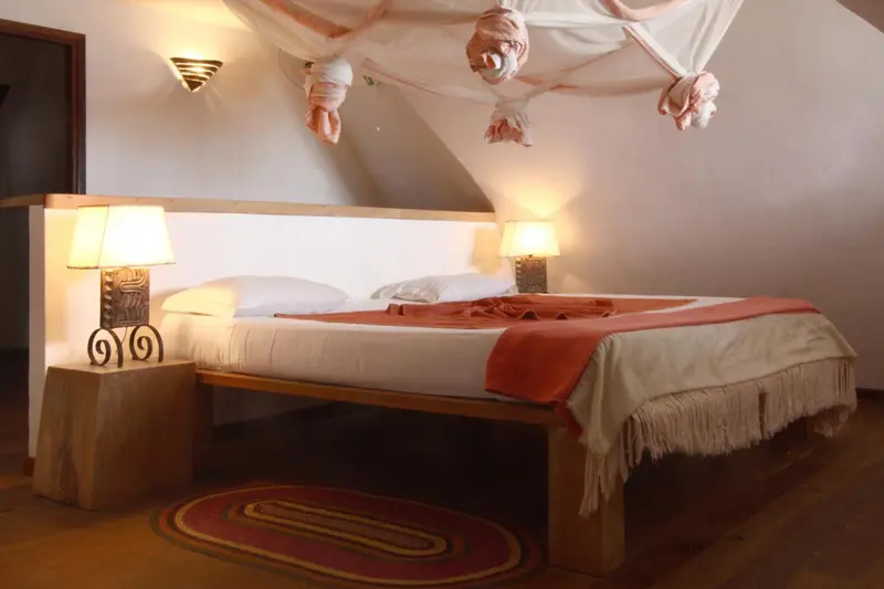Une chambre à coucher avec un lit à baldaquin et une décoration chaleureuse.