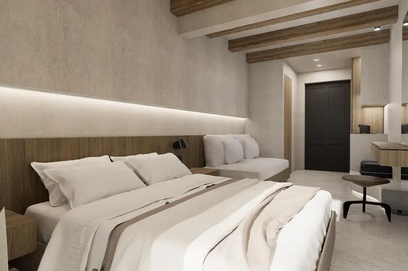 Une chambre lumineuse avec un grand lit et une décoration sobre.