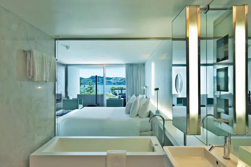 Une chambre lumineuse avec baignoire et vue sur l'océan.