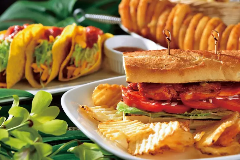Assortiment de tacos et de sandwichs servis avec des frites.