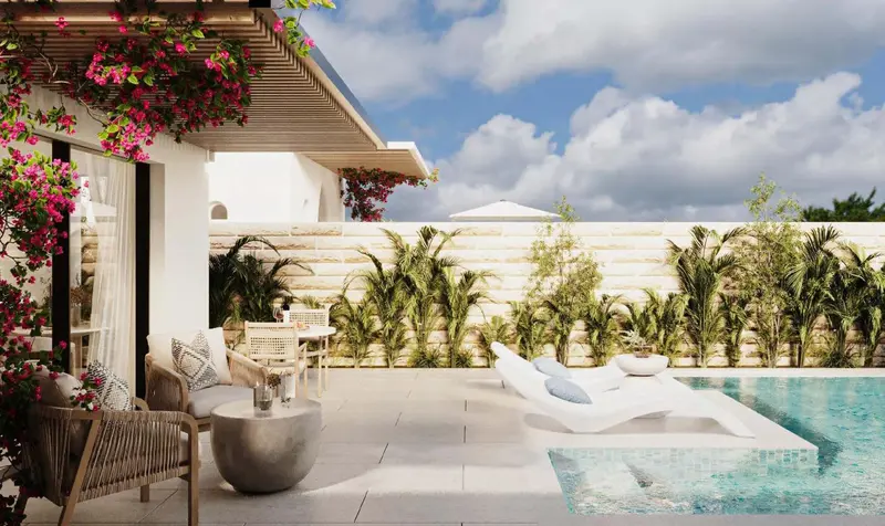 Terrasse aménagée avec salon et transats près d'une piscine.