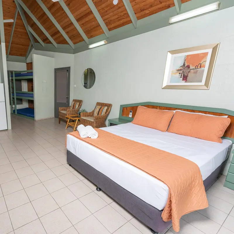 Une chambre lumineuse avec un grand lit et un espace détente.