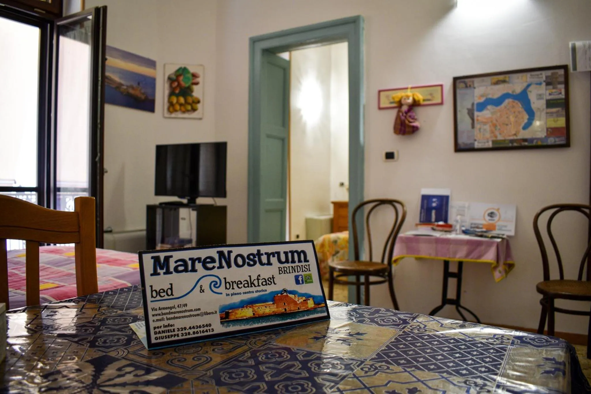 Une table avec une nappe à motifs est mise en scène dans une salle à manger lumineuse.