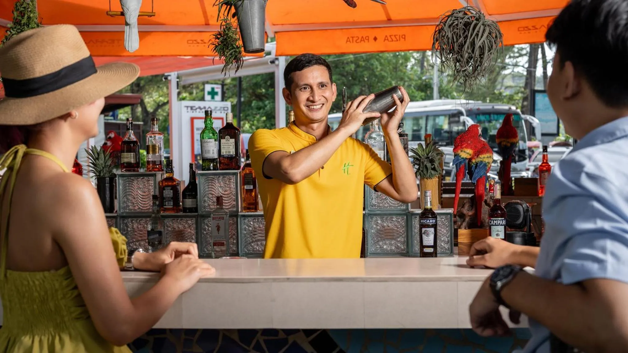 Un barman prépare des cocktails pour des clients en bord de mer.