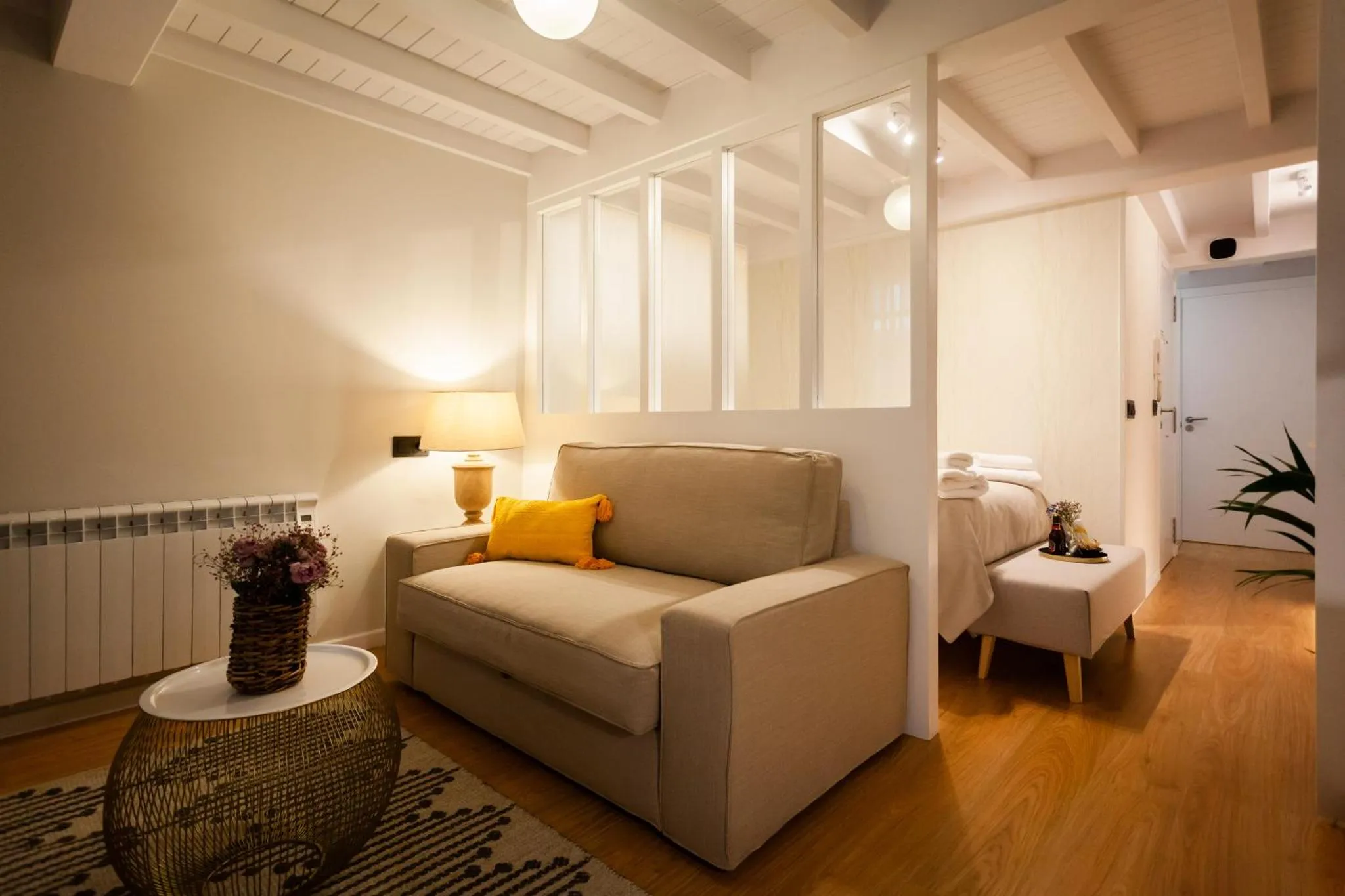 Un canapé beige et une table basse dans un espace de vie lumineux.