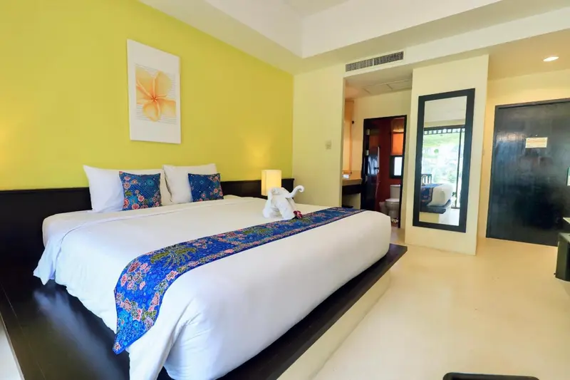 Une chambre lumineuse avec un grand lit et une décoration florale.