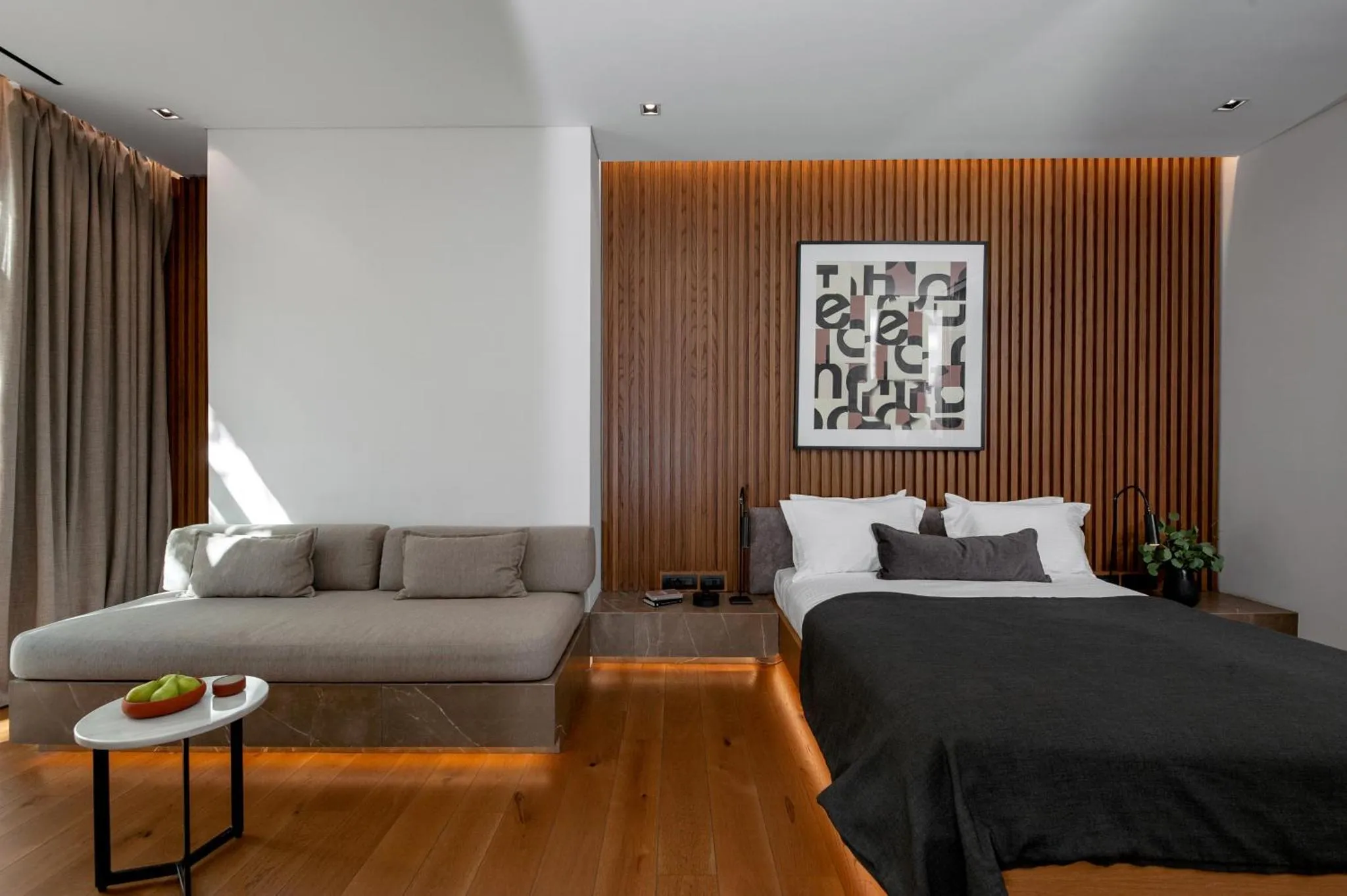 Espace de vie moderne avec canapé d'angle et lit double.