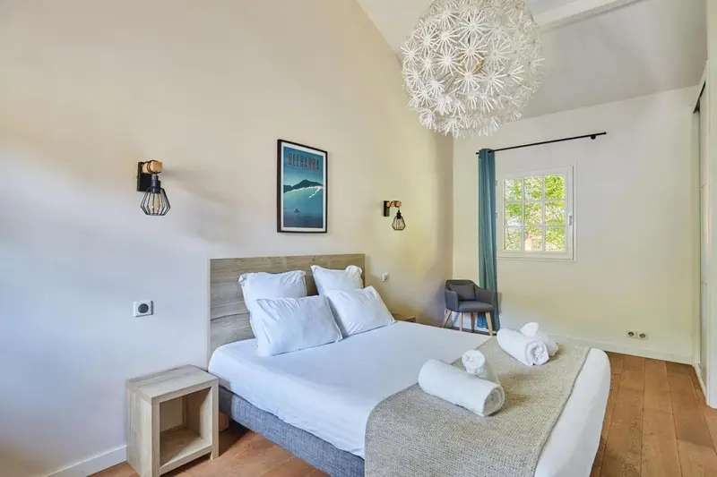 Une chambre lumineuse avec un grand lit et une décoration moderne.