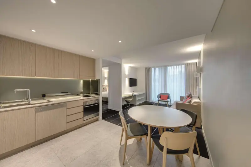 Une cuisine ouverte sur un espace repas et un salon.