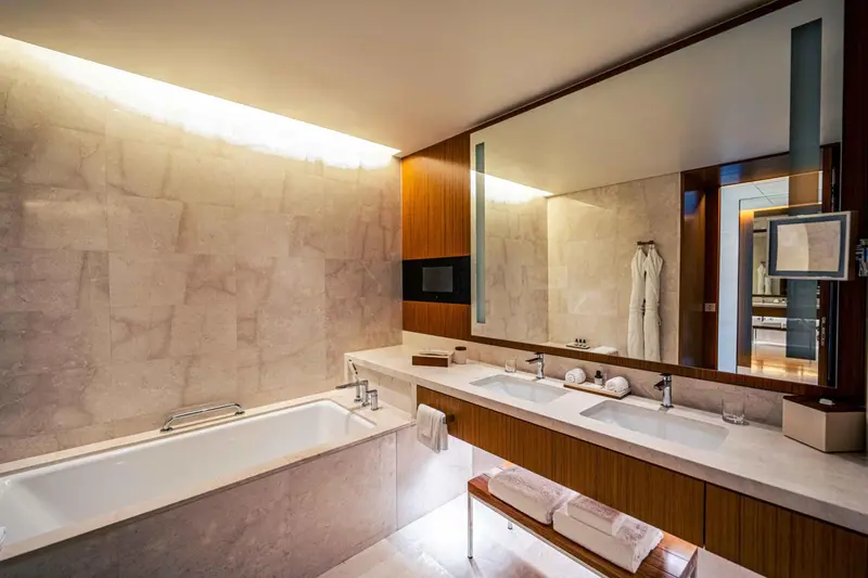 Une salle de bain moderne avec baignoire et deux vasques.
