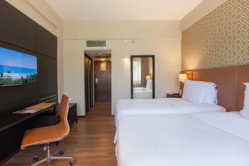Chambre d'hôtel avec un lit double et un bureau.