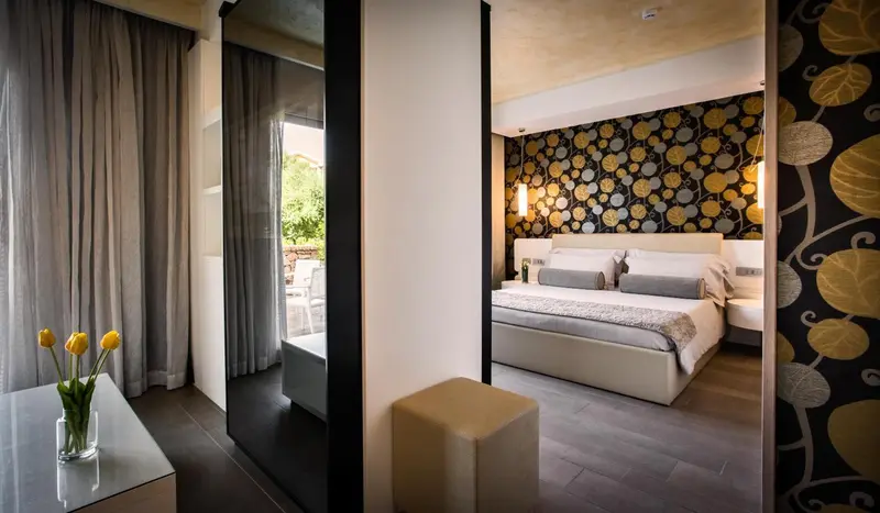 Une chambre lumineuse avec un grand lit et un décor floral.