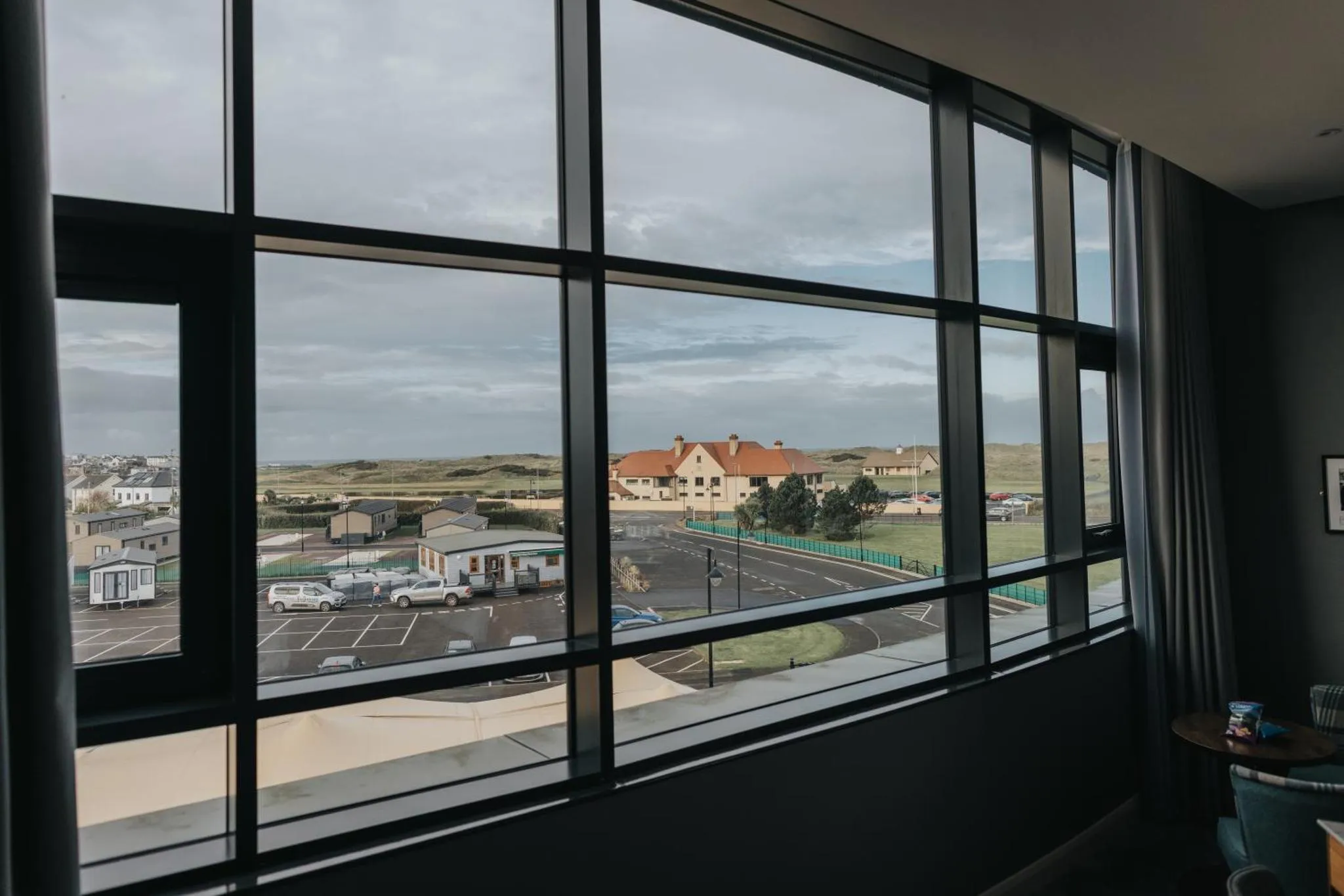Vue sur un paysage côtier depuis une fenêtre.
