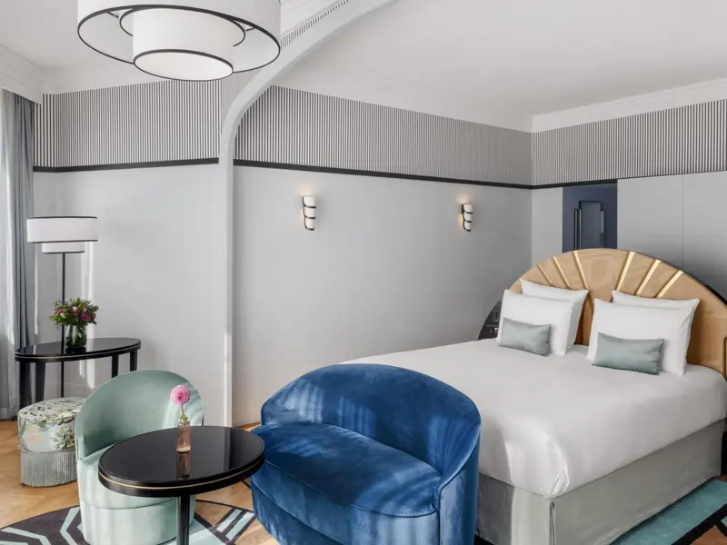Une chambre d'hôtel moderne avec un lit et un coin salon.