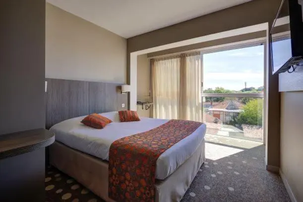 Une chambre avec un lit double donnant sur une terrasse.