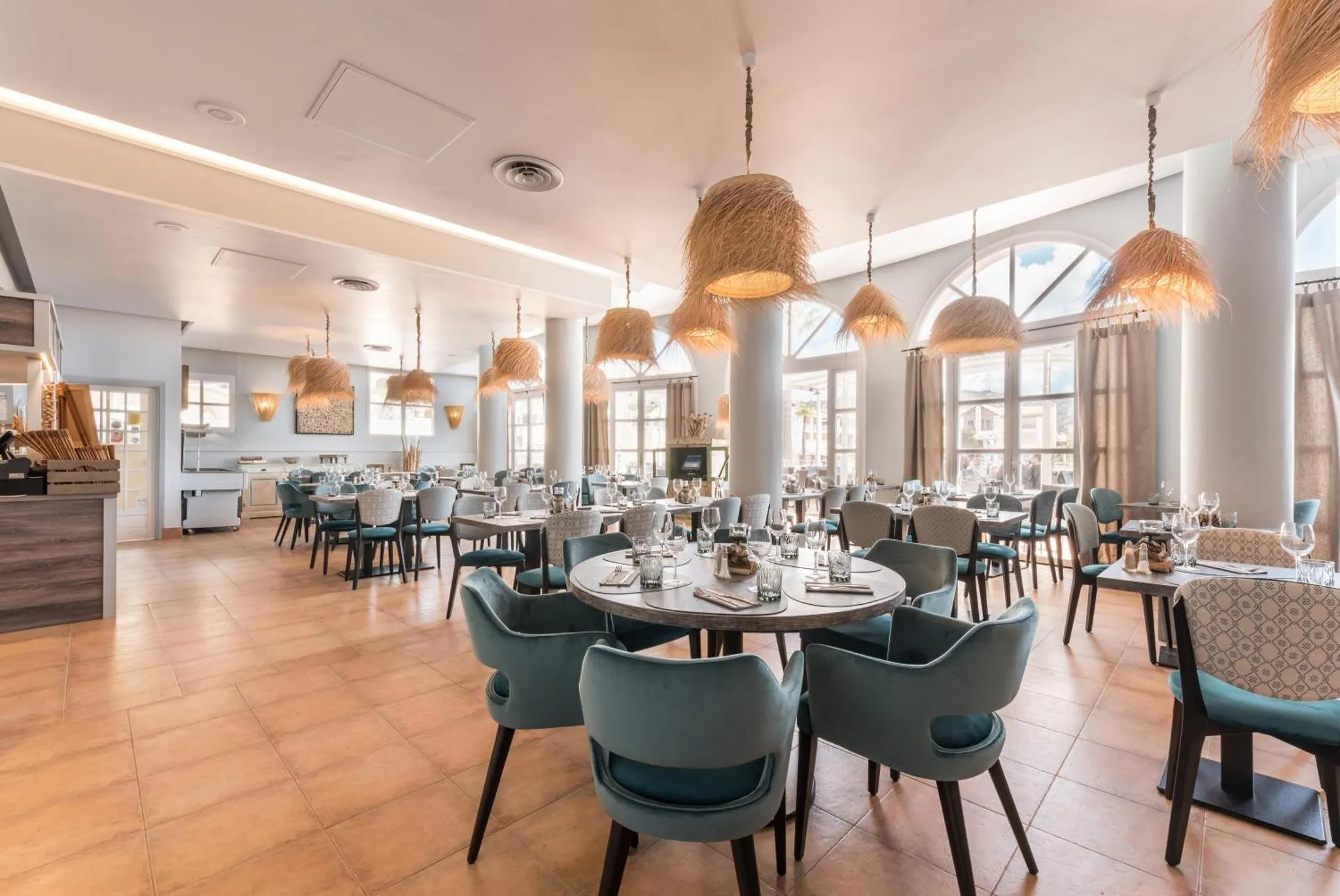 Une salle lumineuse avec des tables et des chaises pour les repas.