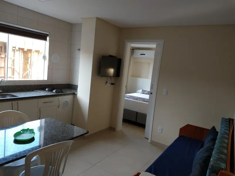 Une cuisine ouverte sur un espace de vie avec un canapé et une chambre.