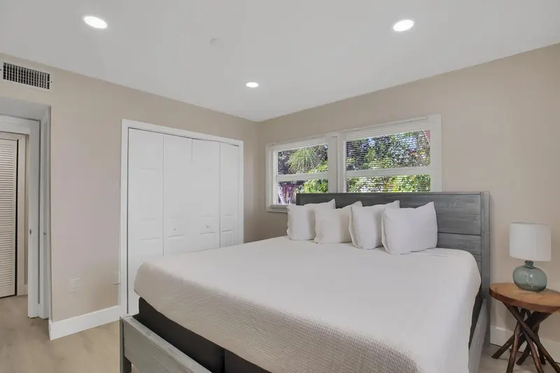 Une chambre lumineuse avec un grand lit et une fenêtre.