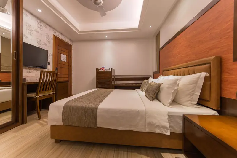 Une chambre lumineuse avec un grand lit et un bureau.
