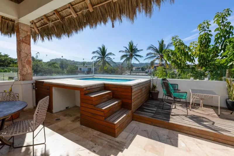 Terrasse avec jacuzzi et mobilier de jardin.