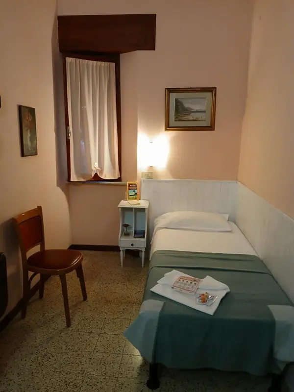 Une chambre simple avec un lit et une table de chevet.