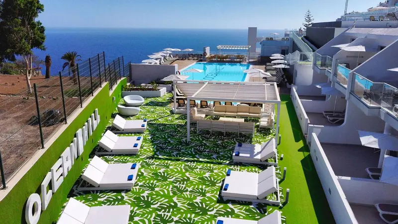 Vue aérienne d'une piscine avec des transats et un espace détente.