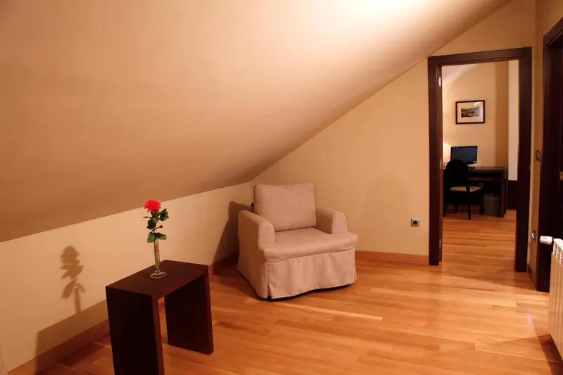 Un coin salon avec un fauteuil et une table d'appoint.