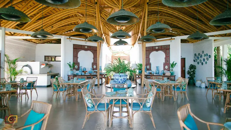 Une salle à manger lumineuse avec des tables dressées et une décoration soignée.