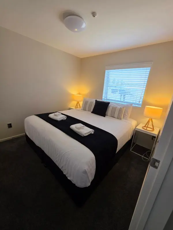 Une chambre lumineuse avec un grand lit et une fenêtre.